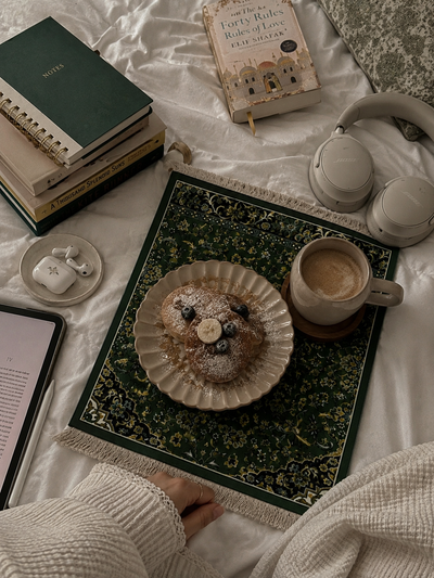 Rawdah inspired Islamic desk mat displayed on luxury marble desk with laptop, mouse, coffee and stationery, olive green Madinah floral design.